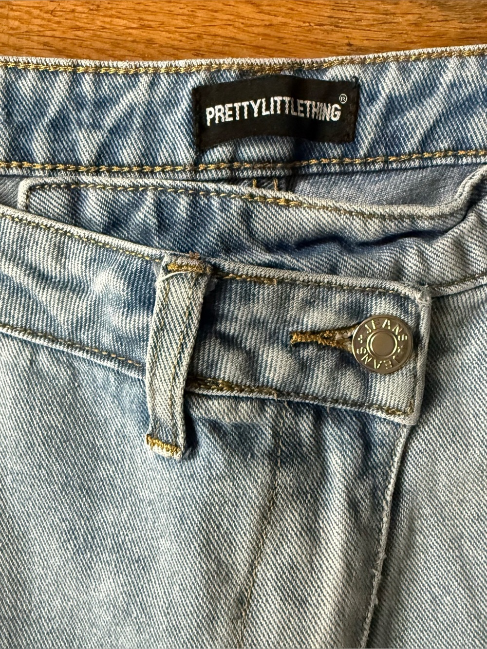 Pretty Little Thing Asymmetrical Waist size 4 light wash jeans